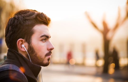 Image of a man listening with ear buds