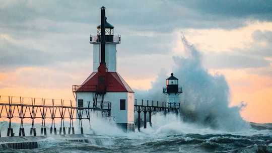 Image of a lighthouse battered by huge waves