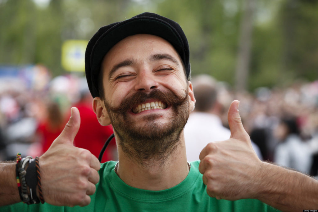 Image of smiling man with two thumbs in the air