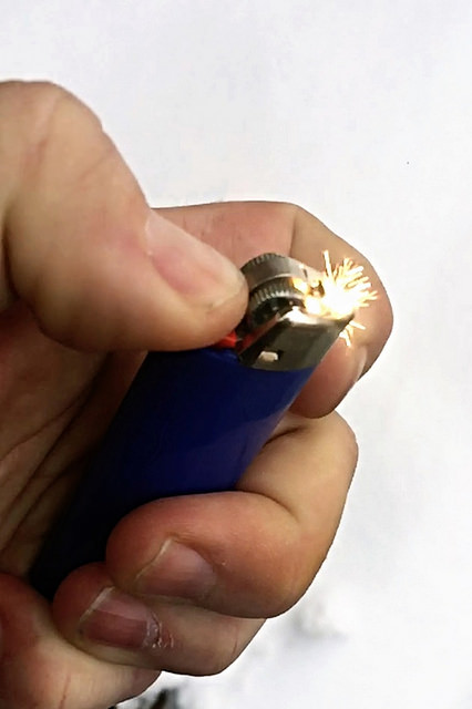 Image of hand flicking a lighter