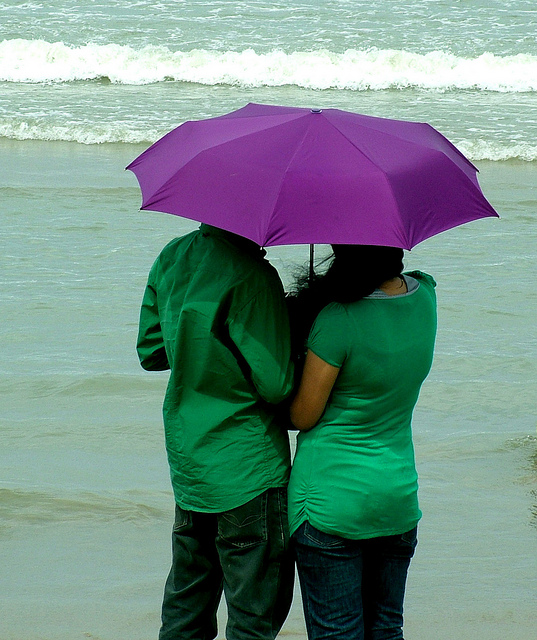 Image of two people under an umbrella