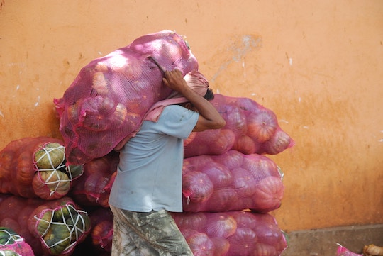 Image of a man carrying a heavy sack