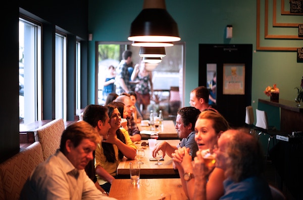 Image of people conversing at a table