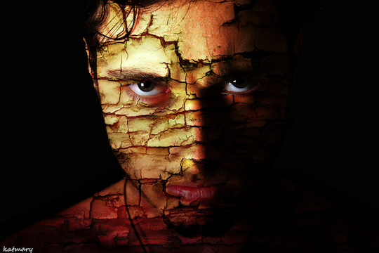 dark image of a man's fractured face