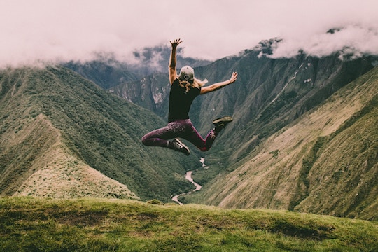 Image of a man leaping for joy on a mountain top