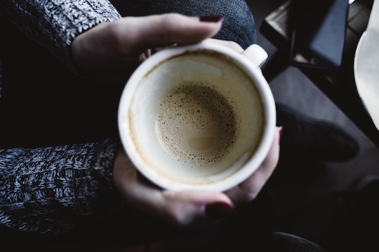Image of hands holding a coffee cup