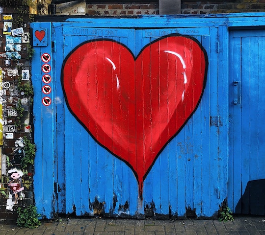 Image of a blue barn door with a large red heart painted on it