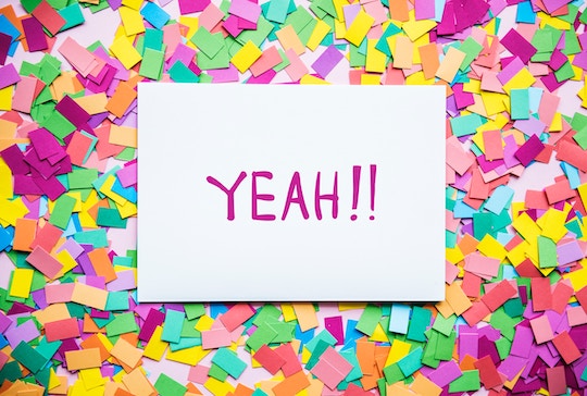 Image of confetti topped by a sign that says, "Yeah!"