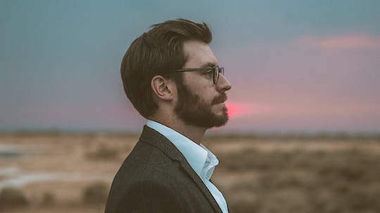 Image of a man's profile, with the sunset behind him