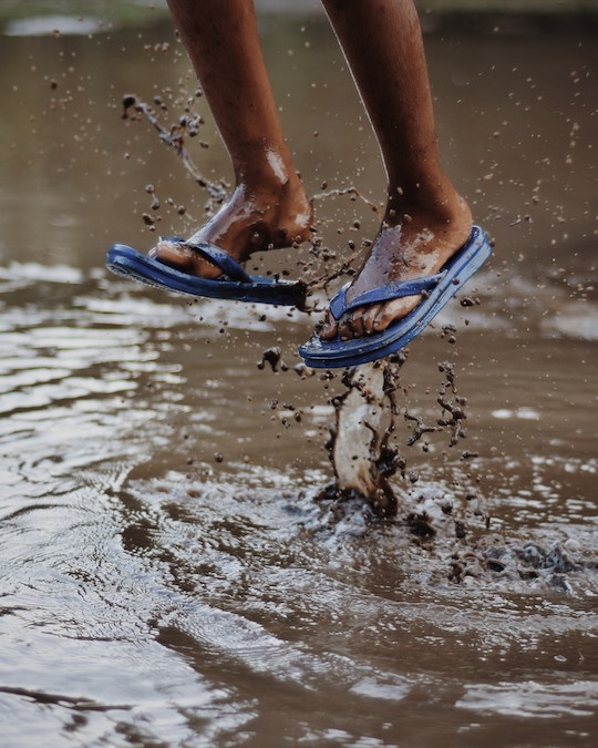 Image of feet jumping in muddy water
