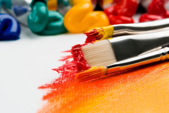Image of paint brushes and bright colors
