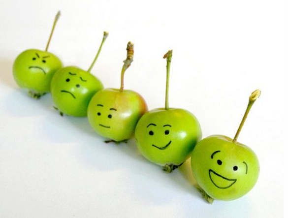 Image of apples in a row with faces from happy to sad