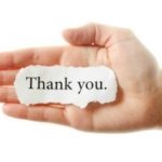 hand with scrap of paper that says "Thank You"