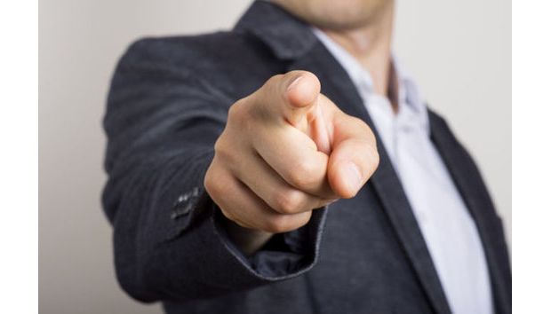 Image of a man pointing one finger with three fingers pointing at himself