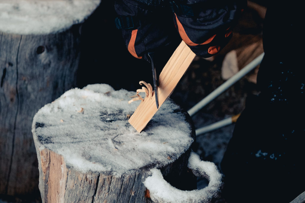 Image of a person whittling on a piece of wood