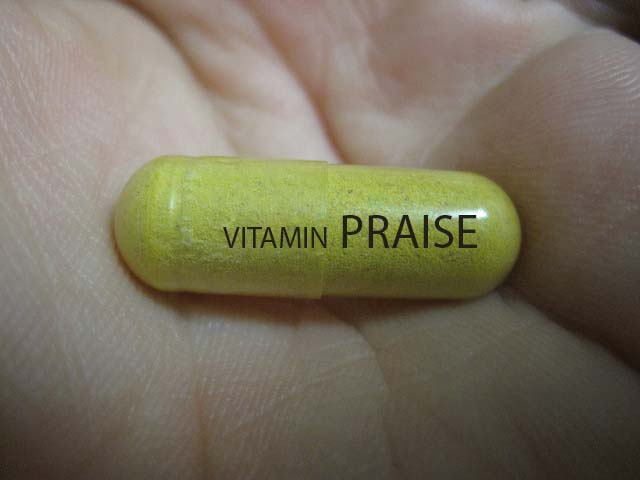imge of a "praise pill" in a hand
