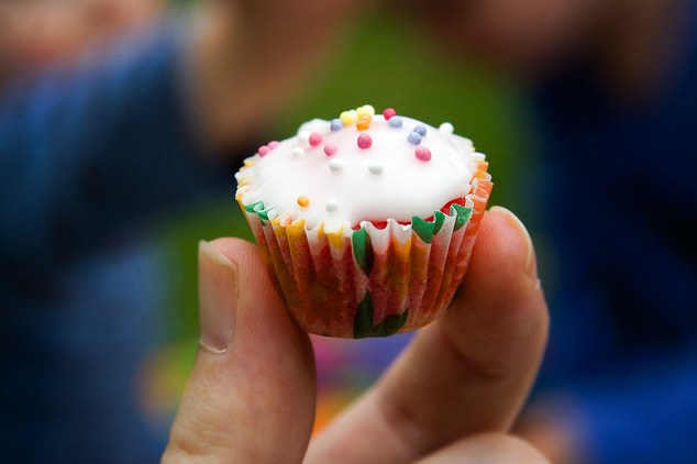 image of a hand holding a bite-sized cupcake