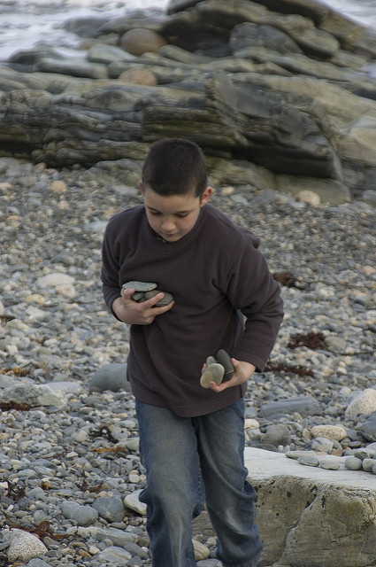 Image of a boy carrying stones