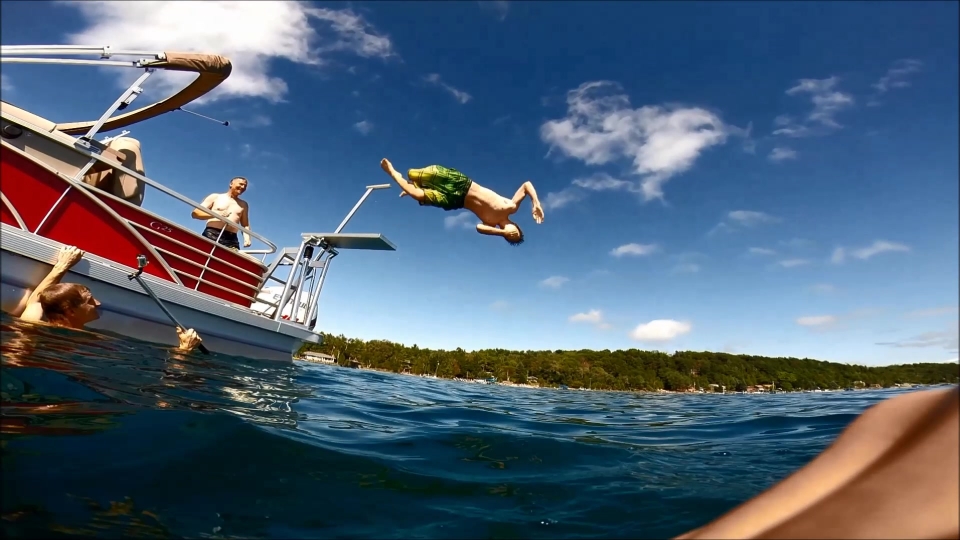 Image of boy diving from a boat