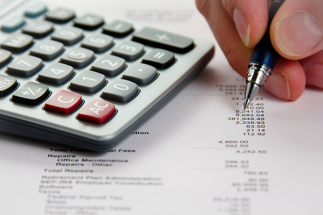 Image of a calculator and a balance sheet