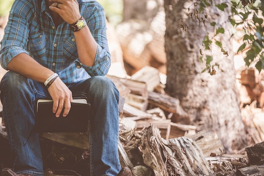 Image of a man sitting on a log