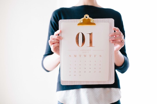 Image of a woman holding a calendar