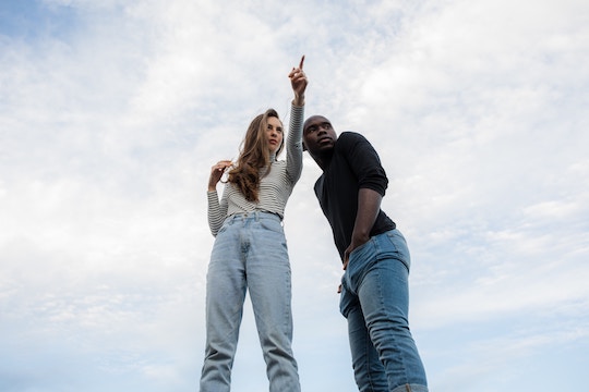 Image of a woman pointing the way for a man