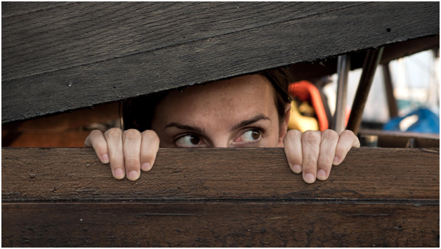 Image of a man hiding in a box