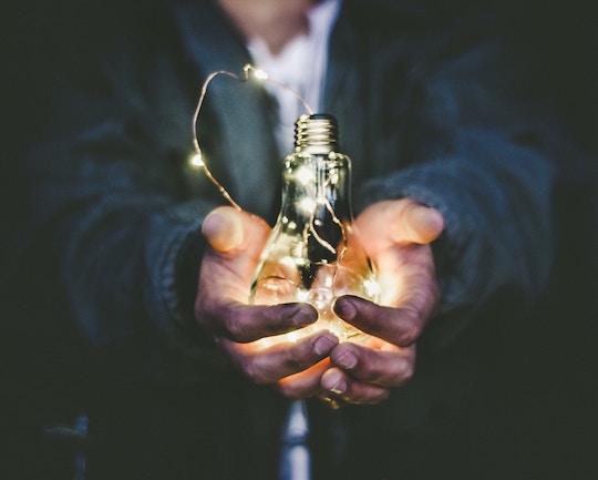 Image of a man holding a large lightbulb