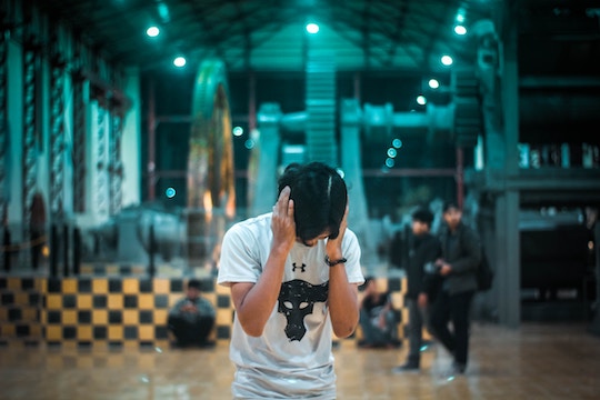 Image of a man holding his ears to block out noise