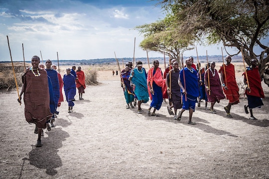 Imaage of African people in colorful dress walking