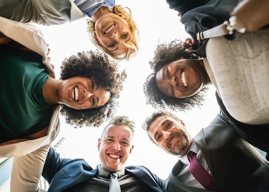 Image of a circle of people looking down at the camera