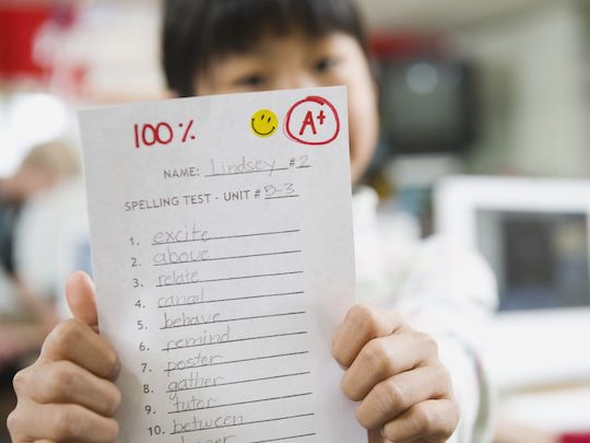 Image of a boy with an A+ paper