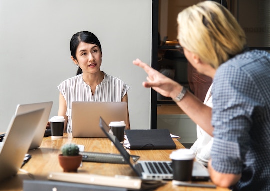 Image of two people talking at a business meeting