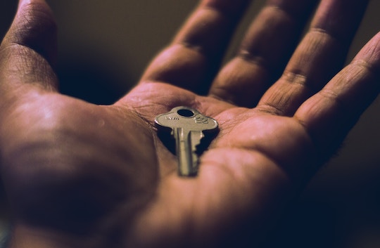 Image of a hand holding a single key