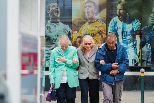 Image of three senior citizens at a sporting event