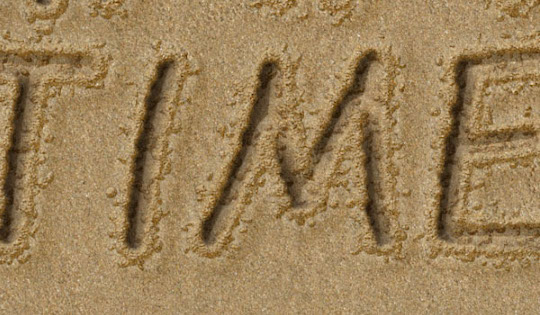 Image of "Time" written in the sand