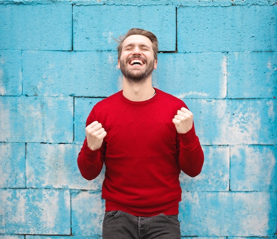 Image of a man smiling and pumping his fists